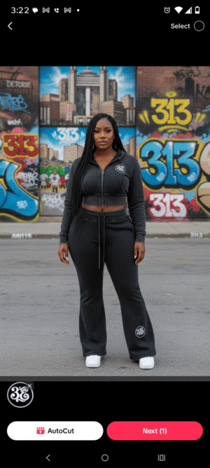 A woman standing on a rooftop with the Detroit skyline and Renaissance Center in the background. She is wearing the 313 Emblems "Black Girl Power" bundle, featuring a black short-sleeve crop top with the "Black Girl Powers Activate" superhero graphic and a matching black mini skirt detailed with a circular 313 emblem on the hip and white piping.